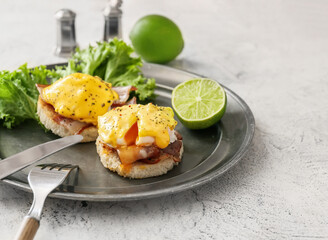 Plate with tasty eggs Benedict on table