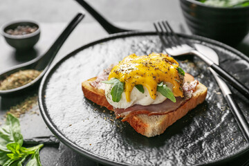Plate with tasty egg Benedict on table, closeup