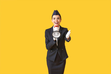 Beautiful stewardess with megaphone on color background