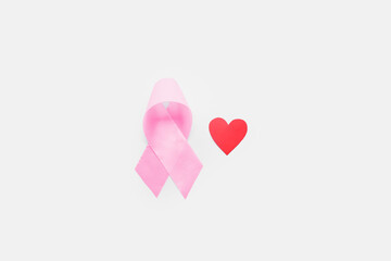Pink ribbon with heart on light background. Breast cancer awareness concept