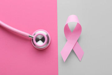Pink ribbon and stethoscope on color background. Breast cancer awareness concept