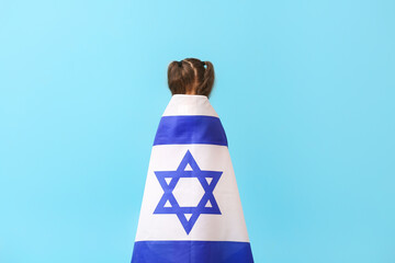 Little girl with the flag of Israel on color background