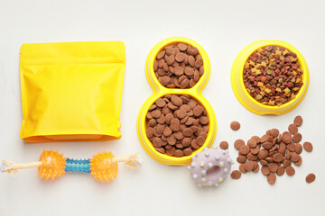 Tasty pet food and accessories on white background
