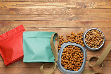 Tasty pet food and leash on wooden background