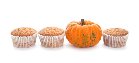Tasty pumpkin muffins on white background