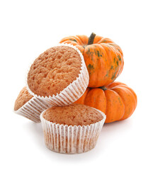 Tasty pumpkin muffins on white background