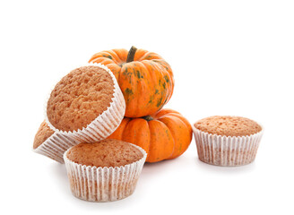 Tasty pumpkin muffins on white background