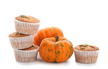 Tasty pumpkin muffins on white background