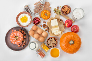 Ingredients for preparing pumpkin pie on white background