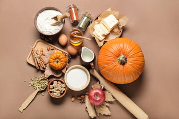 Fototapeta na wymiar Ingredients for preparing pumpkin pie on color background
