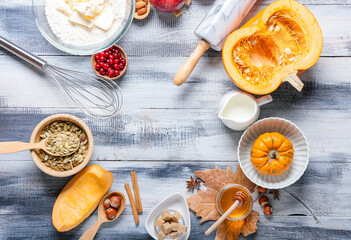 Frame made of ingredients for preparing pumpkin pie on wooden background