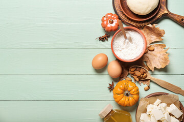 Ingredients for preparing pumpkin pie on color wooden background