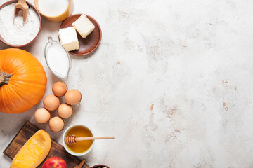 Ingredients for preparing pumpkin pie on light background
