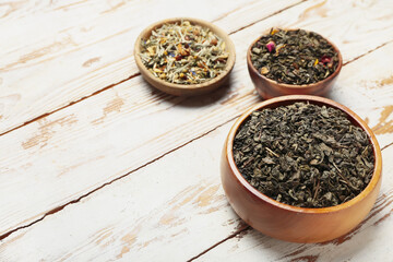 Bowls with different sorts of fruit tea on table