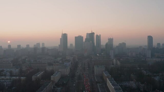 Sun breaking through the fog during sunrise in Warsaw. Aerial