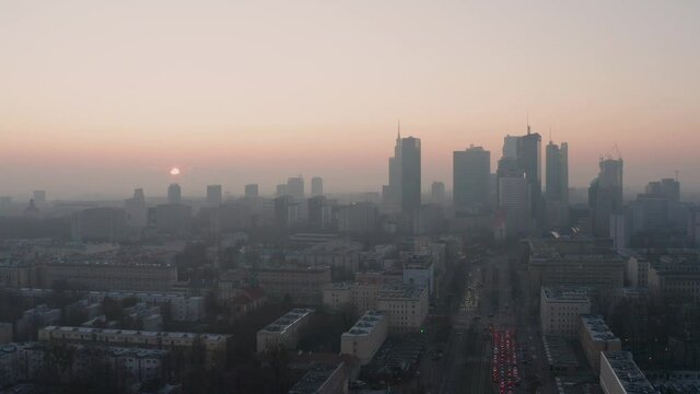 Sun rising on a foggy morning in Warsaw. Aerial drone fottage.