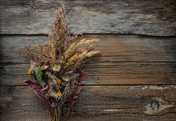 bouquet of dried autumn flowers on old wooden table. autumn season background. fall time concept. minimal style. flat lay