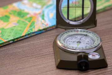 Close-up of a military compass on a map of Russia. Determining the direction of the compass.