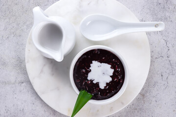 Indonesian traditional dessert: Bubur Ketan Hitam or black glutinous rice porridge with coconut milk sauce.