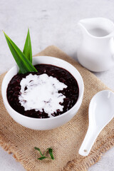 Indonesian traditional dessert: Bubur Ketan Hitam or black glutinous rice porridge with coconut milk sauce.