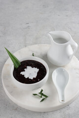 Indonesian traditional dessert: Bubur Ketan Hitam or black glutinous rice porridge with coconut milk sauce.
