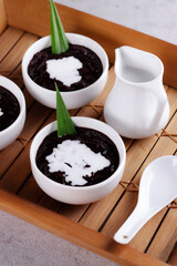 Indonesian traditional dessert: Bubur Ketan Hitam or black glutinous rice porridge with coconut milk sauce.