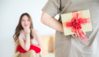 Young couples give each other gifts to celebrate Christmas or New Year.