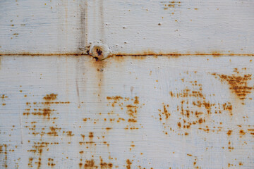 On a rough wall or floor, paint flakes off. Corrosion and rust of metal. Old dilapidated wall.