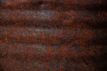 On a rough wall or floor, paint flakes off. Corrosion and rust of metal. Old dilapidated wall.