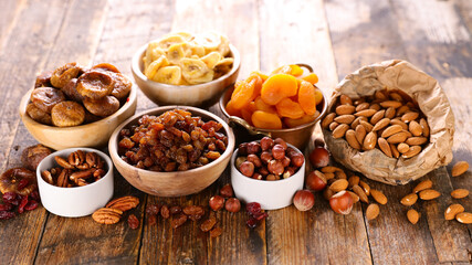 nuts and dried fruit on wood background