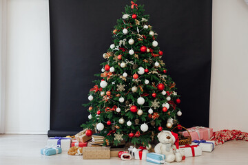 Christmas tree with gifts in the interer lights garland decor new year