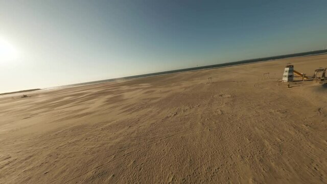 Masterly drone shot of a vegetative and vast powdery sandy beach with background turquoise sea.