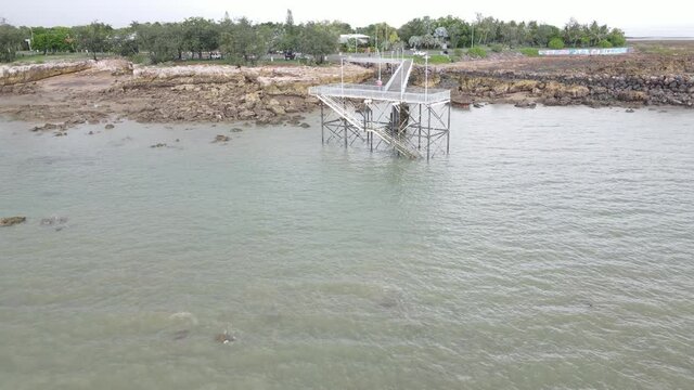 Low moving drone shot of NightCliff Pier in Darwin, Northern Territory