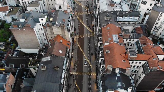 Aerial forwarding flight while drone is following white car in Brussels' streets, Belgium.