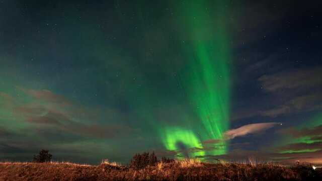 Beautiful green northern lights dancing in the night sky -time lapse