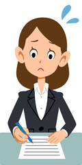 困った表情で書類に記入するビジネスウーマン
