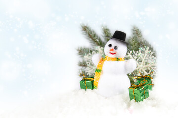 Christmas composition on a white background with a snowman, green spruce branches and gifts with copy space.