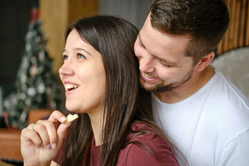 Young couple making breakfast and having fun