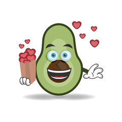 Avocado mascot character holding a love icon. vector illustration
