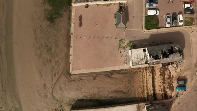 Aerial topdown flight over Old Leigh fishing village Leigh On Sea showing rooftops of shipyards moored boats and business on the wharf 50fps mavic 2 pro