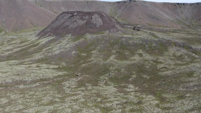 Reveal shot of large volcanic crater in front of Geitafell slopes