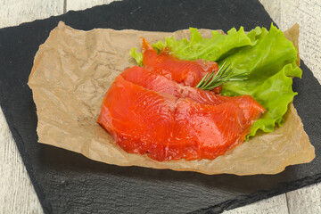 Sliced salmon fillet served rosemary