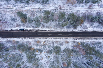 road through winter forest, top view