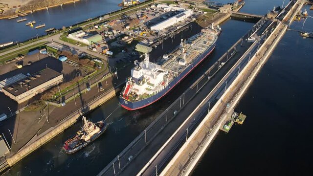 Large ship going through the largest sluice in the world the sluice is still under construction. large infrastructure project.