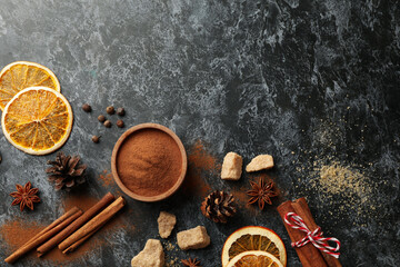 Ingredients for cooking mulled wine on black smokey background