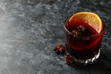 Glass of mulled wine on black smokey table
