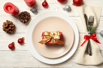 Concept of New year table setting with gift box on wooden table