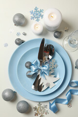 Concept of New year table setting with decorative snowflakes on white background