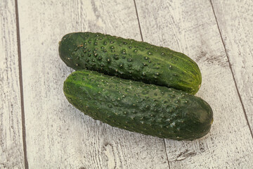 Green fresh cucumbers over background