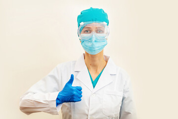 Doctor or nurse showing thumbs up on beige background, measles injection syringe for baby, man, woman vaccination, medicine and drug concept. Vaccination against Coronavirus covid-19 pandemic. End flu